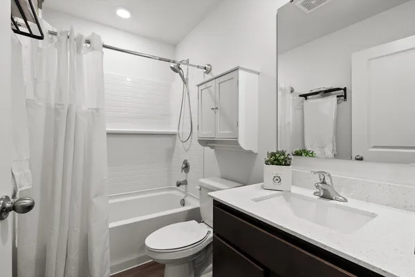 a bathroom with a sink toilet tub and shower