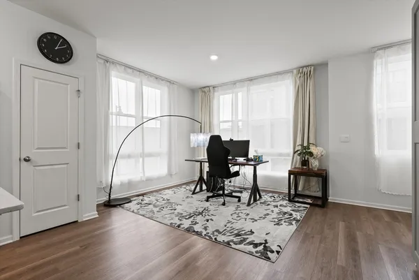 a view of a workspace with furniture and a window