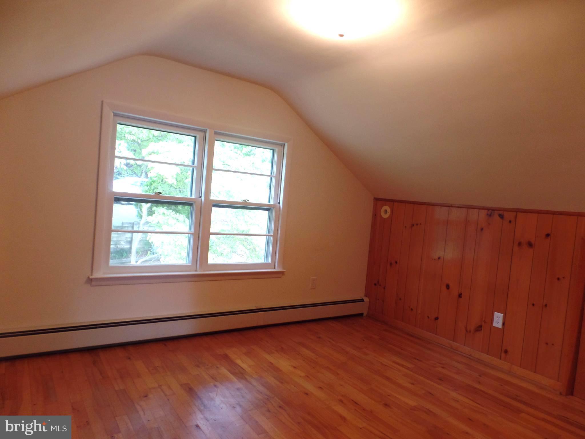1636 Exeter Road Westminster, MD 21157 - Photo 15 of 23 an empty room with wooden floor and windows with curtains