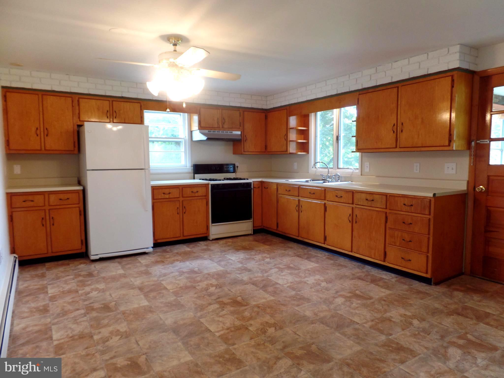 1636 Exeter Road Westminster, MD 21157 - Photo 5 of 23 a kitchen with stainless steel appliances granite countertop a stove a sink and a refrigerator