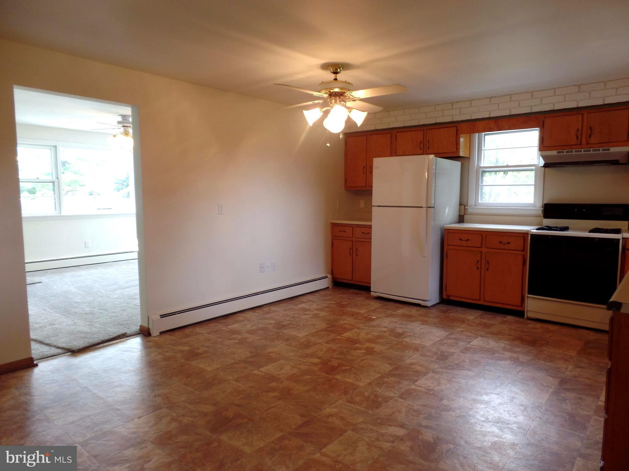 1636 Exeter Road Westminster, MD 21157 - Photo 7 of 23 a view of a kitchen with a stove cabinets and wooden floor
