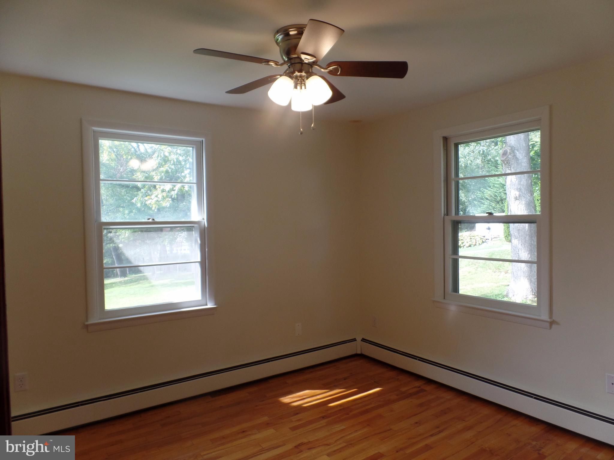 1636 Exeter Road Westminster, MD 21157 - Photo 9 of 23 a view of an empty room with wooden floor and a window