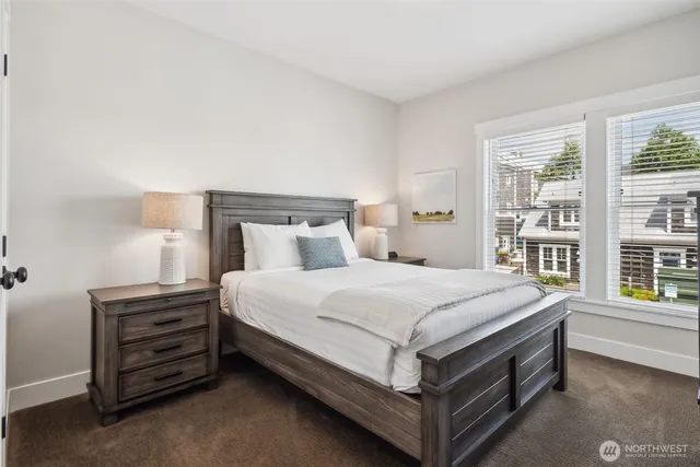 a bed sitting in a bedroom next to a window