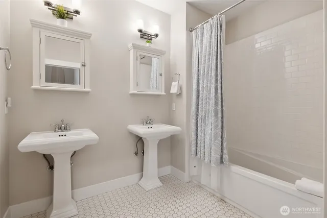 a bathroom with a sink a mirror toilet and bathtub