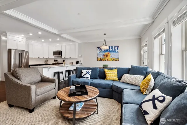 a living room with furniture and kitchen view
