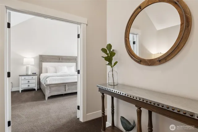 a bedroom with a bed and a mirror