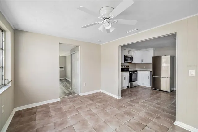 a view of a kitchen with refrigerator and windows