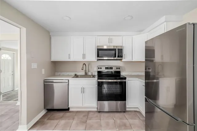 a kitchen with a refrigerator stove and microwave