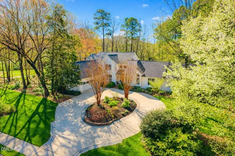an aerial view of a house with yard swimming pool and outdoor seating
