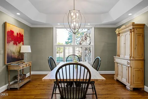 a large kitchen with a large counter top a sink stainless steel appliances and cabinets