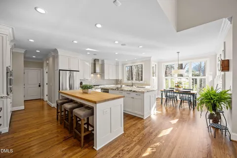a kitchen with stainless steel appliances granite countertop white cabinets and a microwave oven