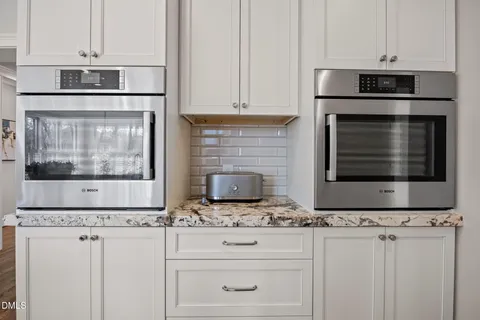 a kitchen with granite countertop a sink and a stove