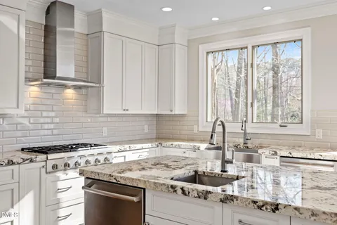 a close view of a stove a sink and dishwasher in a kitchen