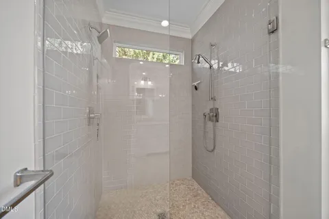 a bathroom with a granite countertop double vanity sink and a mirror