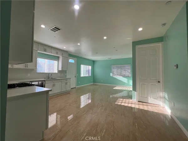 a view of a kitchen with a sink and cabinets