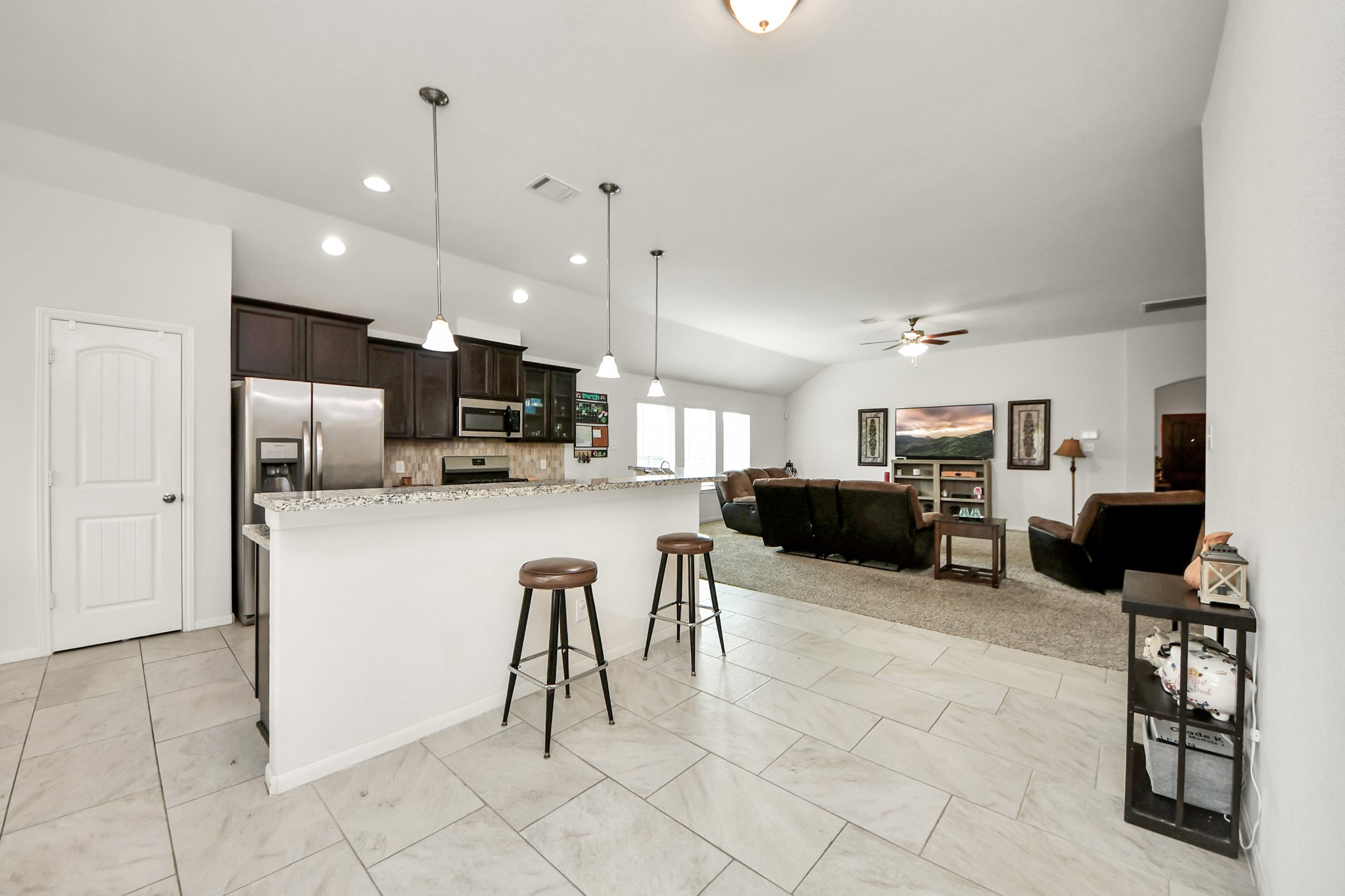 6226 Mason Way Rosenberg, TX 77471 - Photo 5 of 30 a kitchen with stainless steel appliances kitchen island granite countertop a refrigerator and cabinets