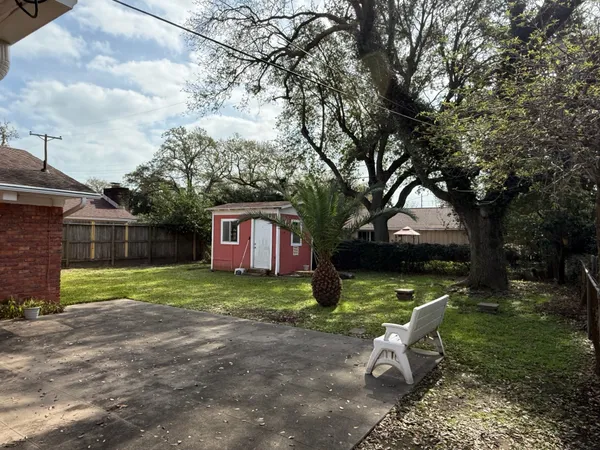a view of a wooden deck and a yard