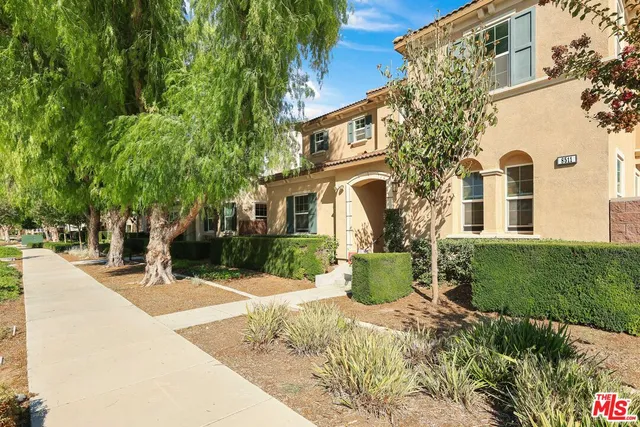 a view of a white house with a yard