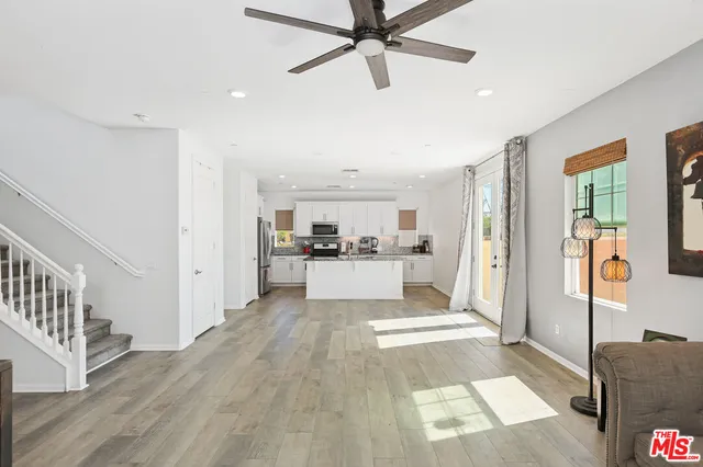 a view of a living room with furniture and wooden floor