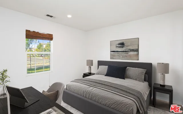 a bedroom with a bed and a window