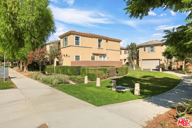 a view of a white house with a yard