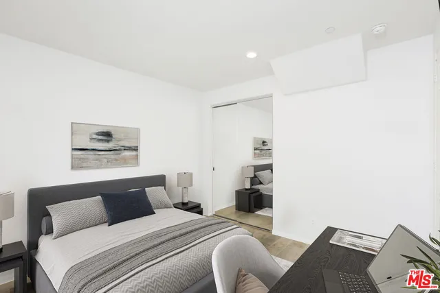 a bedroom with a bed and a couch