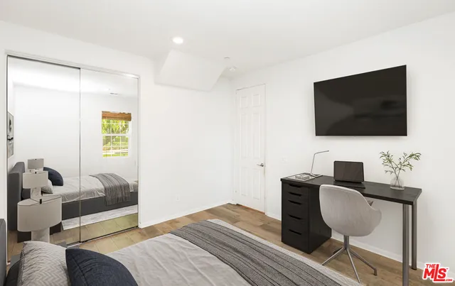 a bedroom with a bed and a flat screen tv