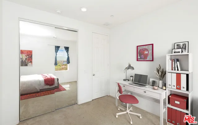 a bedroom with furniture and a book shelf