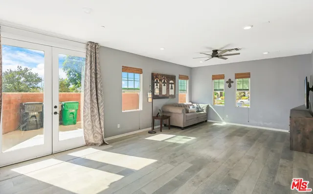 a spacious bedroom with a bed and a large window