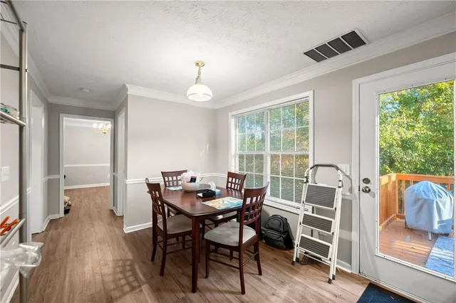 a view of a dining room with furniture window and wooden floor