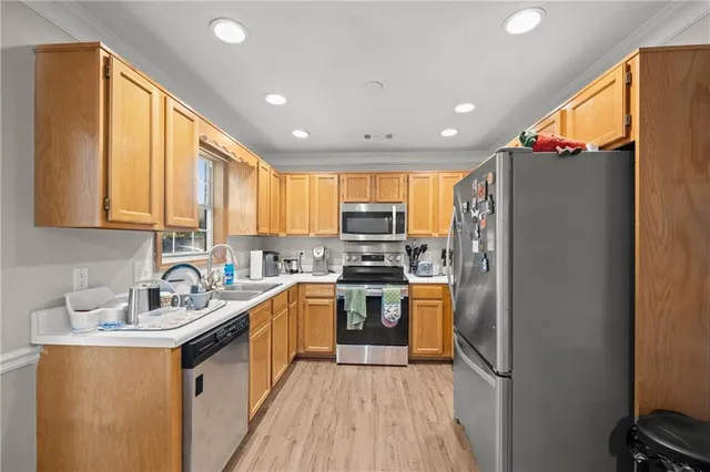 a kitchen with stainless steel appliances granite countertop sink refrigerator and microwave