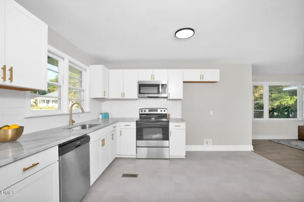 a kitchen that has a sink and a stove