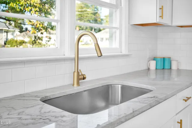 a kitchen with a sink and a window