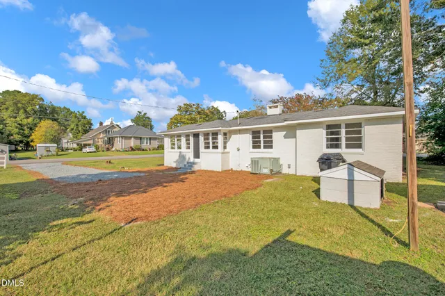 a view of a house with swimming pool and sitting area