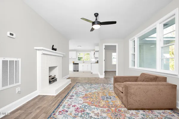 a living room with furniture and a fireplace