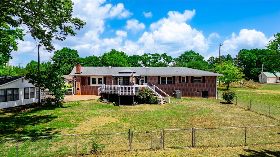 1815 Pearman Dairy Road Anderson, SC 29625 - Photo 23 of 35 A spacious backyard with a generous deck offers ample room for outdoor activities.