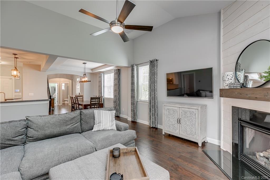 6743 Dusty Saddle Road Charlotte, NC 28277 - Photo 16 of 47 a living room with furniture a flat screen tv and a fireplace