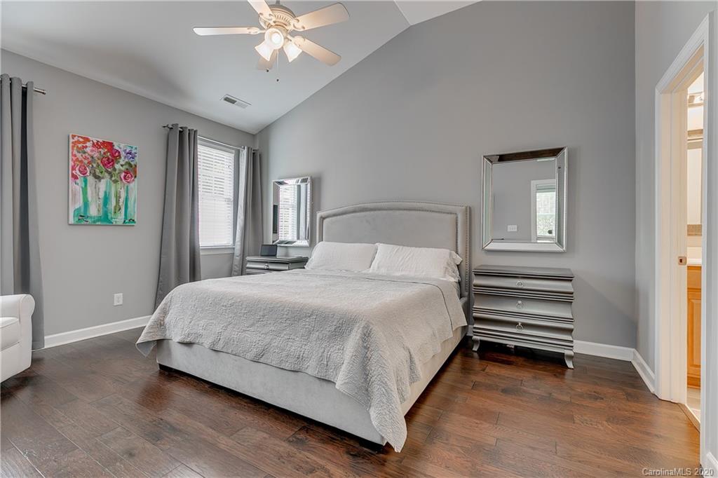 6743 Dusty Saddle Road Charlotte, NC 28277 - Photo 17 of 47 a bedroom with a bed and a chandelier