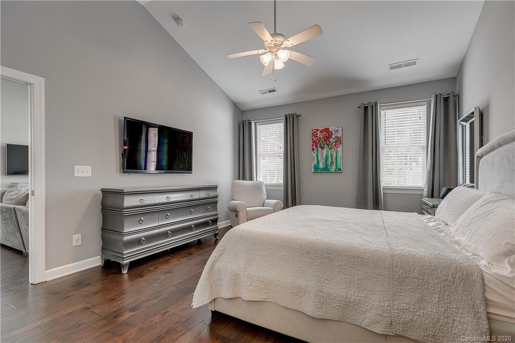 6743 Dusty Saddle Road Charlotte, NC 28277 - Photo 18 of 47 a bedroom with a bed and a chandelier