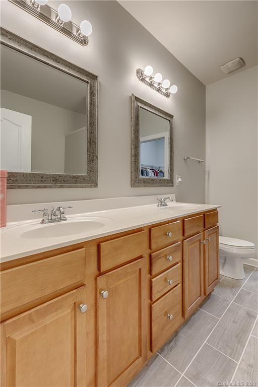 6743 Dusty Saddle Road Charlotte, NC 28277 - Photo 21 of 47 a bathroom with a double vanity sink and a mirror