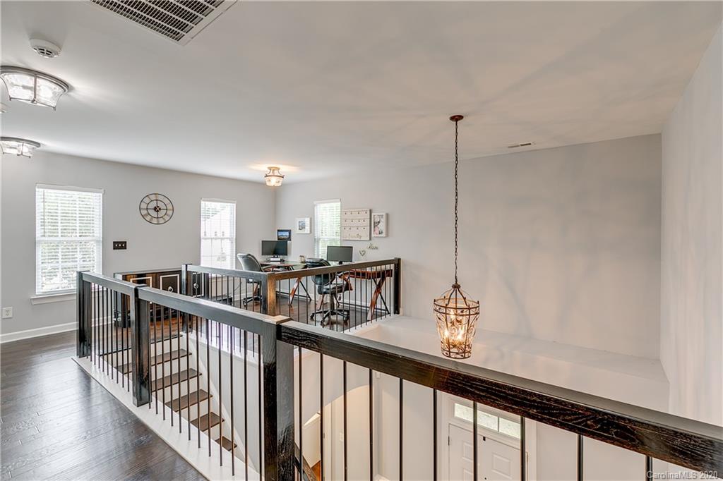 6743 Dusty Saddle Road Charlotte, NC 28277 - Photo 30 of 47 a view of a hallway with wooden floor and windows