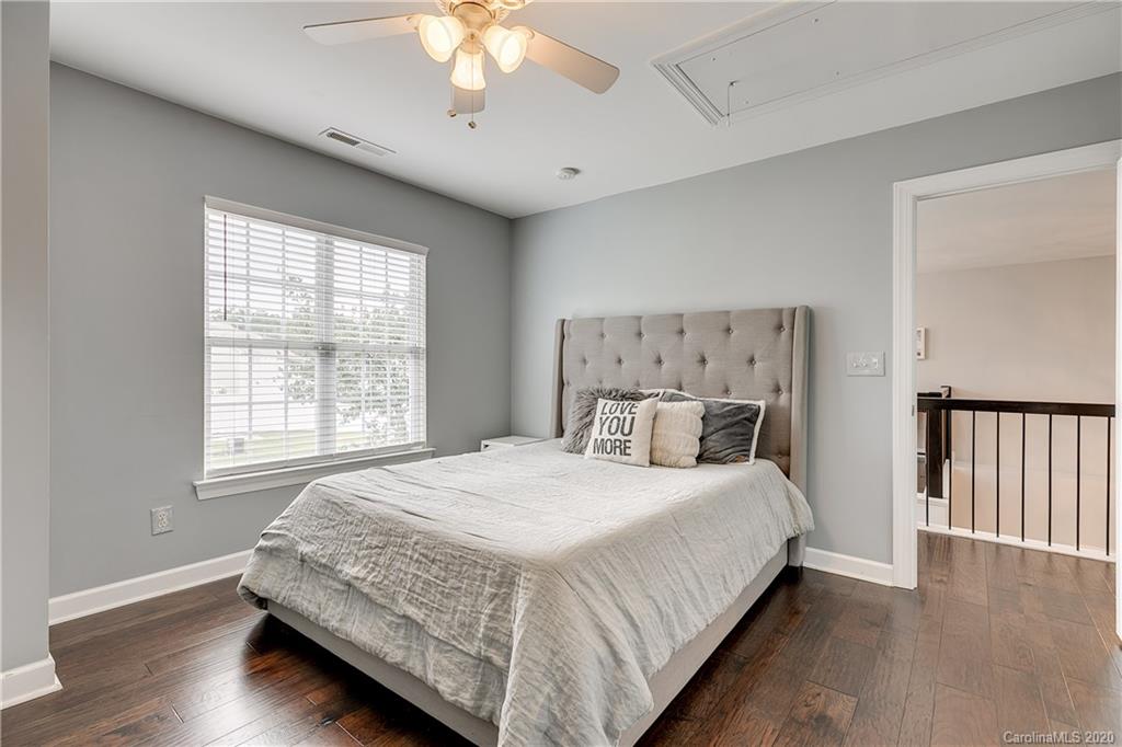 6743 Dusty Saddle Road Charlotte, NC 28277 - Photo 32 of 47 a bedroom with a large bed and a chandelier
