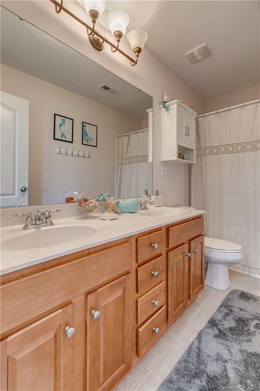6743 Dusty Saddle Road Charlotte, NC 28277 - Photo 37 of 47 a bathroom with a granite countertop sink a toilet and a mirror