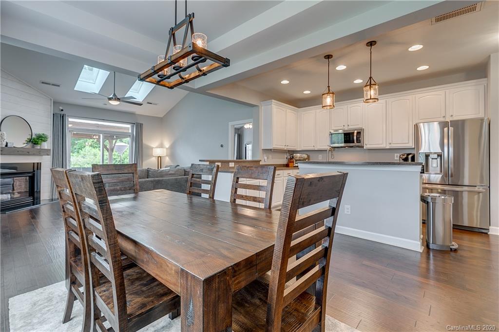 6743 Dusty Saddle Road Charlotte, NC 28277 - Photo 5 of 47 a kitchen with stainless steel appliances granite countertop a stove a refrigerator a kitchen island a table and chairs