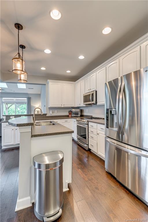 6743 Dusty Saddle Road Charlotte, NC 28277 - Photo 10 of 47 a kitchen with kitchen island granite countertop stainless steel appliances and wooden floor