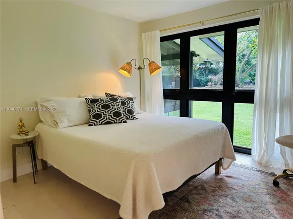a bedroom with a large bed and a large window