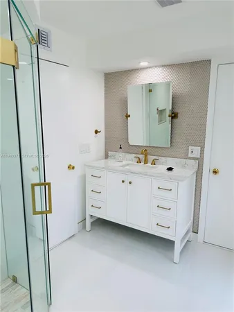a bathroom with a sink a mirror and a vanity