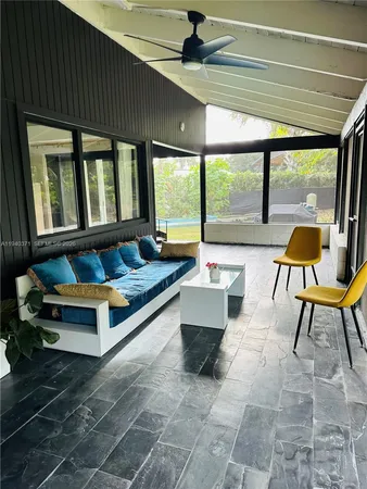 a building outdoor space with patio furniture and a potted plant