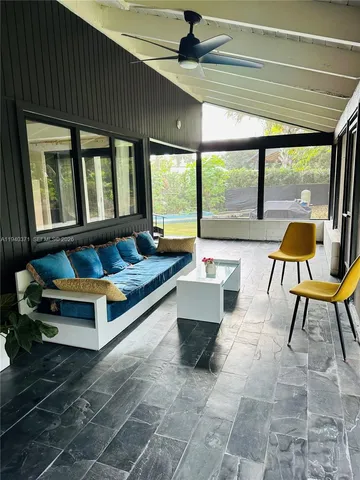 a building outdoor space with patio furniture and a potted plant