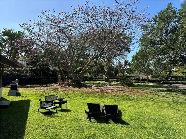 a swimming pool with outdoor seating and yard
